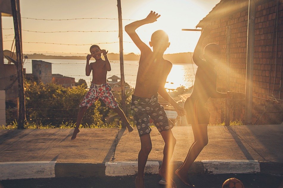 children spin on the street at sunset