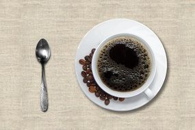 black coffee with coffee beans on the saucer