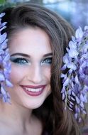 portrait of a beautiful woman with violet flowers