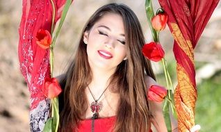 Smiling girl with the red tulips