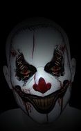 face of man with clown mask for halloween