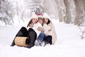 happy girls sit in the snow