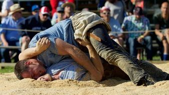 men fight on the field with sawdust