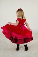 cute little girl in red dress in motion