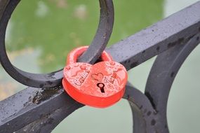 red lock on a metal fence