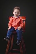 photo session of a little boy in a high big chair