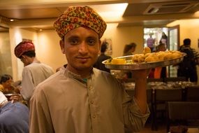 waiter with a tray in india