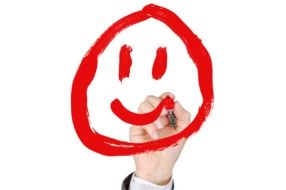 man draws a red smiley