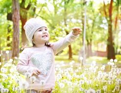 small girl on the dandelion meadow