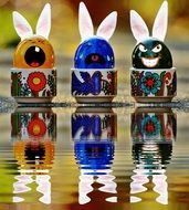 funny easter eggs are reflected in the water