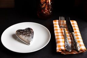 silver brooch on plate and Cutlery