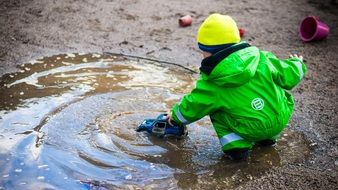 boy playing in the puddle