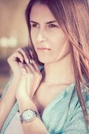 beautiful girl with a clock on her hand