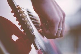 photo of guitar and hand with a wedding ring