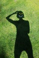 shadow of a girl on green grass