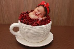 baby in a big tea cup