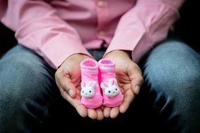 Expecting Baby, pink girl boots on male hands