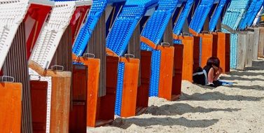 colored deck chairs on the beach