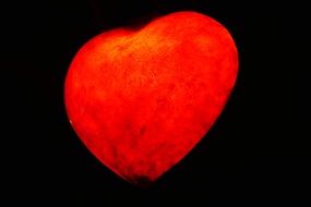 red heart-shaped lantern on a black background