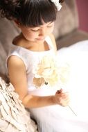 Happy Asian Child Girl with flower in hand