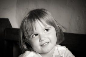 black and white photo of a little happy girl