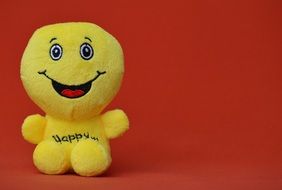 yellow smiley as a stuffed toy