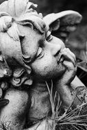 sculpture of a sad angel in a cemetery