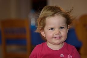 portrait of a smiling little girl on blurry background