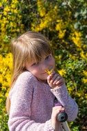 Cute Blond Child Girl with Flower outdoor