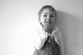 charming little girl near the wall