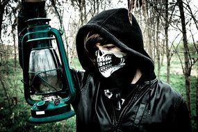 person in Skull mask with Lantern outdoor