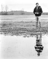 Black and white photo of the man near the water