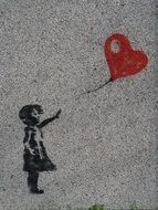 drawing of a girl with a heart-shaped balloon on the wall