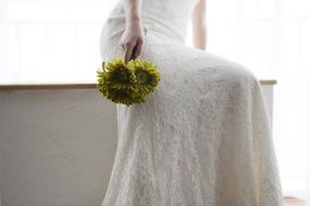 bouquet of yellow flowers in the bride hands