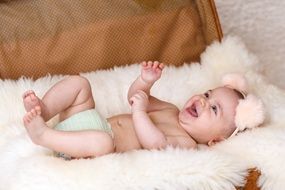 laughing baby on a fluffy blanket