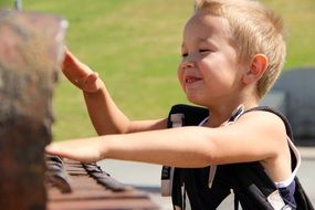 happy boy is playing piano