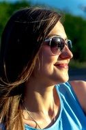 profile portrait of a young woman in sunglasses