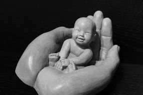 clipart of the asian child in open hands statuette