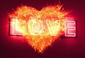 word "love" on a fiery heart