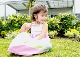 girl in a light dress in a flowered garden