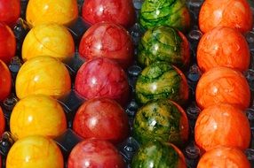 many bright easter eggs in a tray