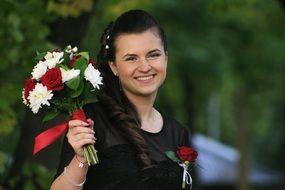 photo of a happy girl with a bouquet in her hands