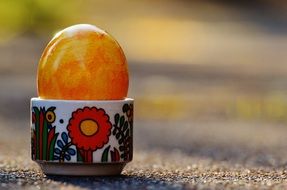 yellow shiny easter egg in stand