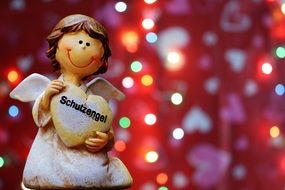angel figure with a heart on a brilliant background