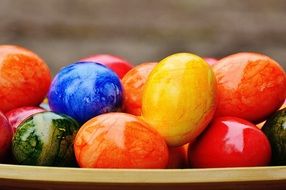 bright shiny Easter eggs on a plate close-up