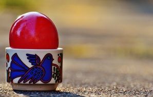 red shiny easter egg in stand
