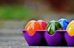 bright brilliant easter eggs in a purple tray