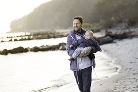 Dad with the boy walking on the beach