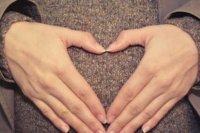 mom's hands on a pregnant belly