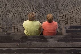 two persons Sitting outdoor, top view